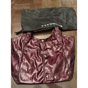 This is a Vittorio patent leather hobo bag in a deep burgundy or plum color